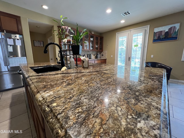 2812 Crocus Pl, Palmdale, CA 93551 - kitchen with freestanding refrigerator, backsplash, french doors, glass insert cabinets, and recessed lighting