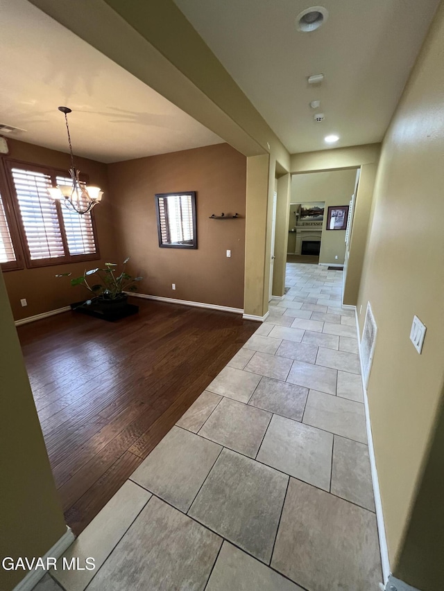 2812 Crocus Pl, Palmdale, CA 93551 - corridor with tile patterned floors and a chandelier
