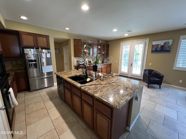 2812 Crocus Pl, Palmdale, CA 93551 - kitchen with stainless steel refrigerator with ice dispenser, backsplash, glass insert cabinets, plenty of natural light, and recessed lighting