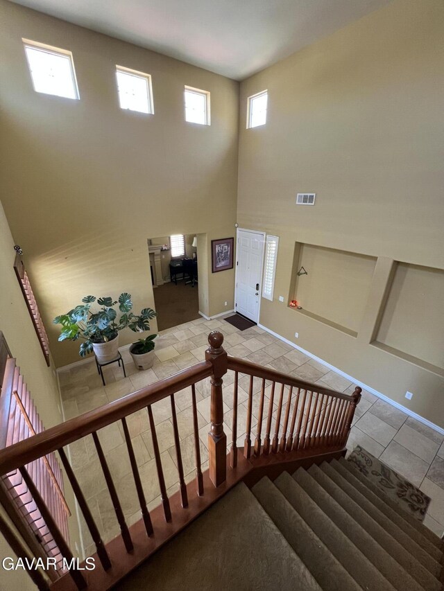 2812 Crocus Pl, Palmdale, CA 93551 - staircase featuring tile patterned floors and a high ceiling