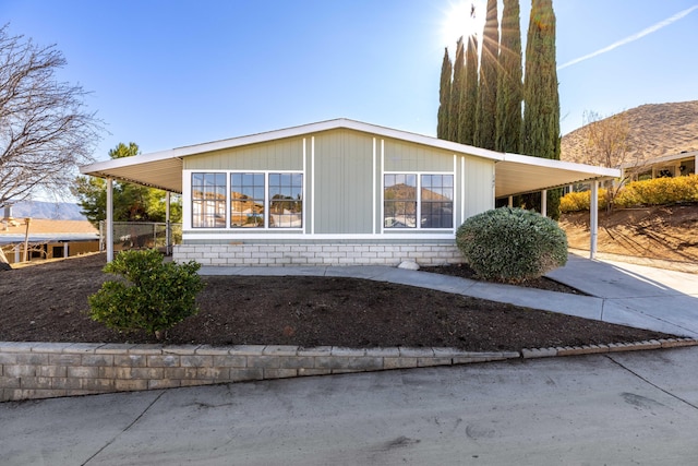 view of home's exterior with a carport and a mountain view