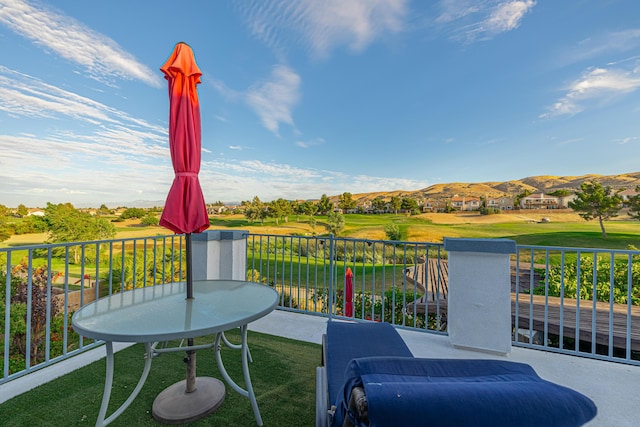 view of patio with a mountain view and a balcony