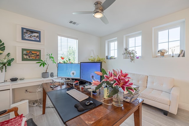 home office featuring light wood-type flooring and ceiling fan