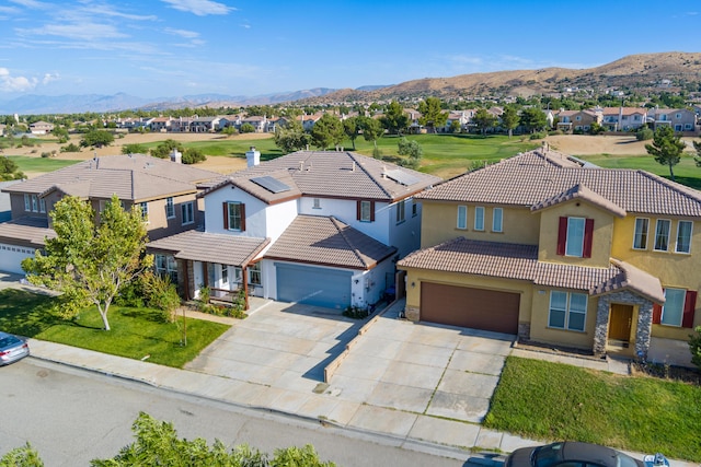 view of front of house with a mountain view and a garage