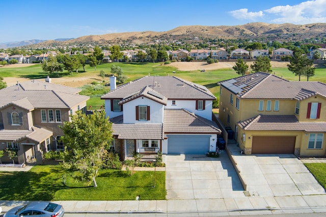 birds eye view of property with a mountain view