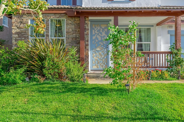 doorway to property with a yard