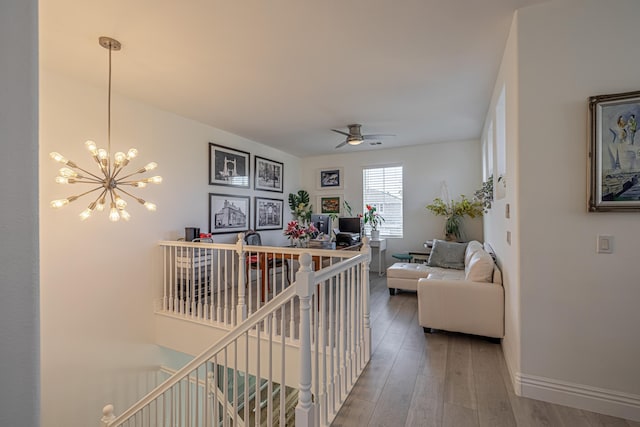 hall with hardwood / wood-style flooring and an inviting chandelier