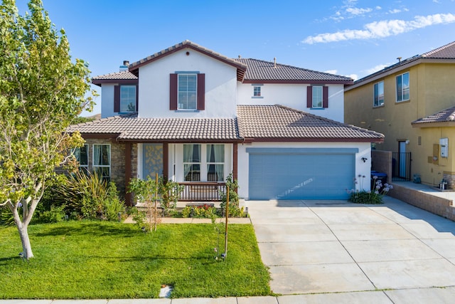 mediterranean / spanish-style home featuring covered porch, a garage, and a front lawn