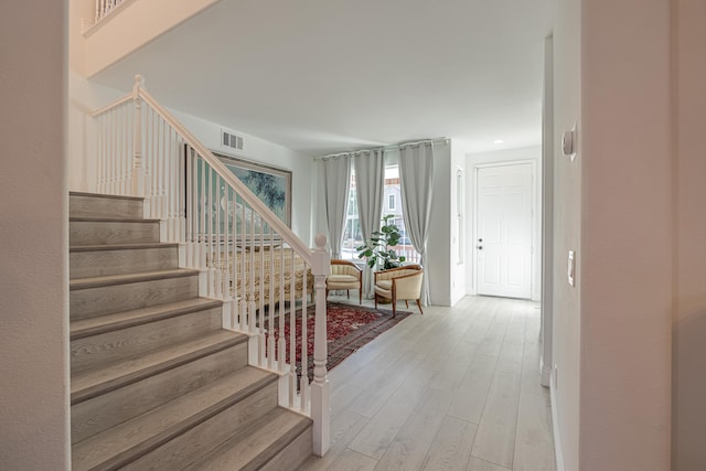 staircase with wood-type flooring