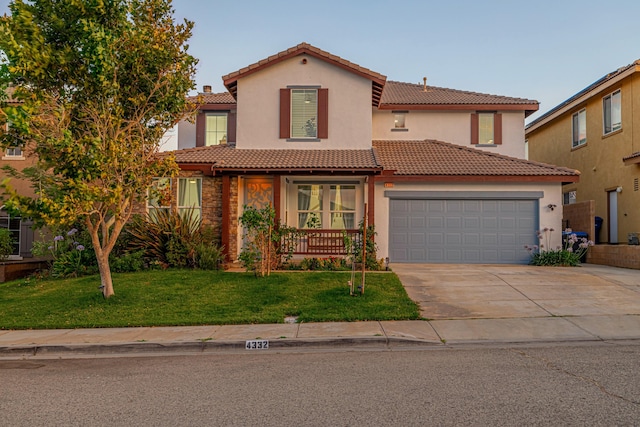 mediterranean / spanish-style house with a front lawn and a garage