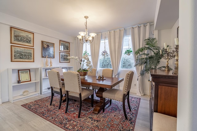 dining space with a chandelier and light hardwood / wood-style floors