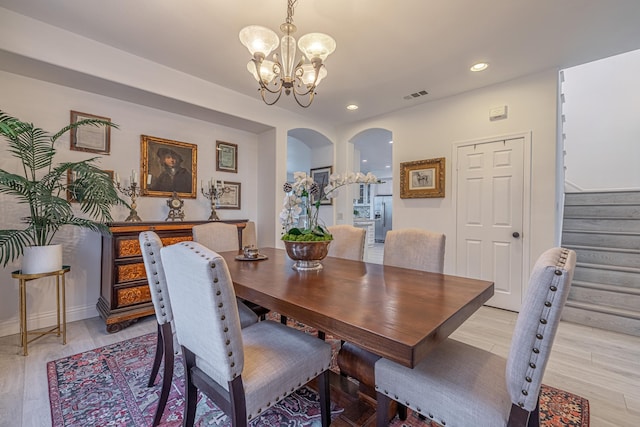 dining room featuring light hardwood / wood-style flooring and an inviting chandelier