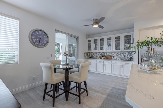 dining room with light hardwood / wood-style floors and ceiling fan