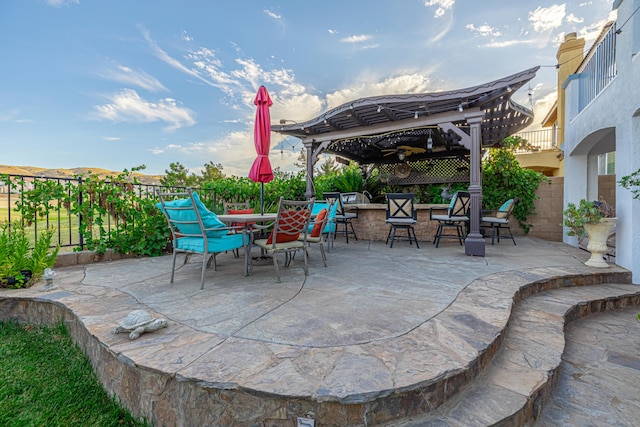 view of patio with an outdoor bar