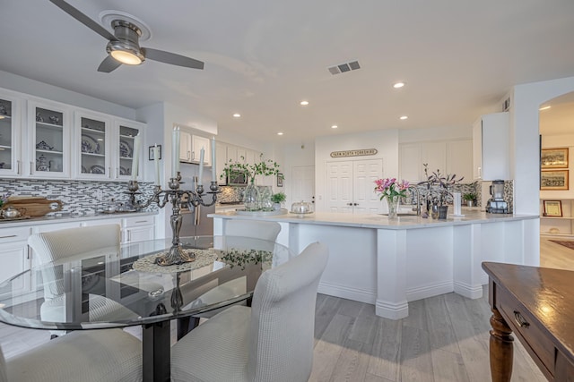 dining space featuring ceiling fan and light wood-type flooring