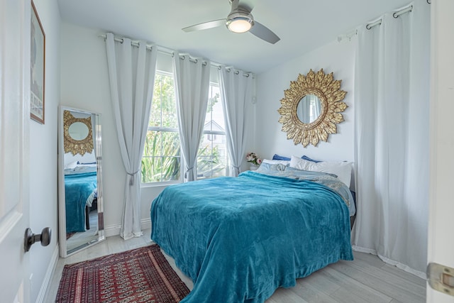 bedroom with light hardwood / wood-style floors and ceiling fan