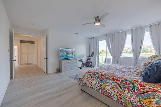 bedroom featuring access to exterior, ceiling fan, and light hardwood / wood-style flooring