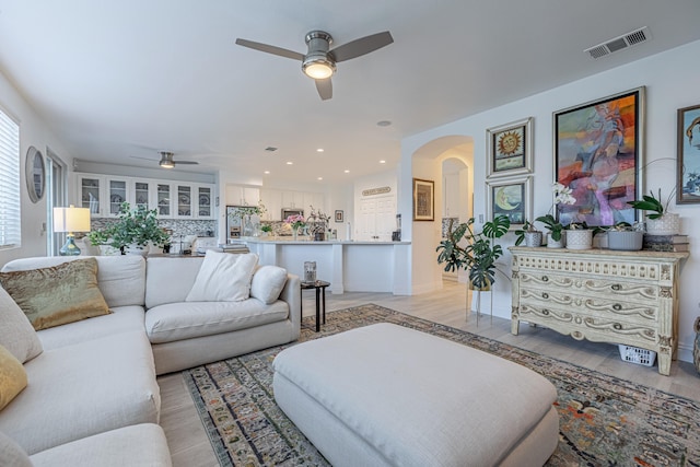 living room featuring light wood-type flooring and ceiling fan