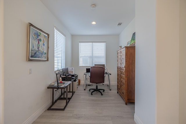 office with light wood-type flooring