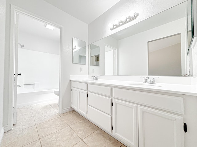 bathroom with tile patterned flooring, vanity, and toilet