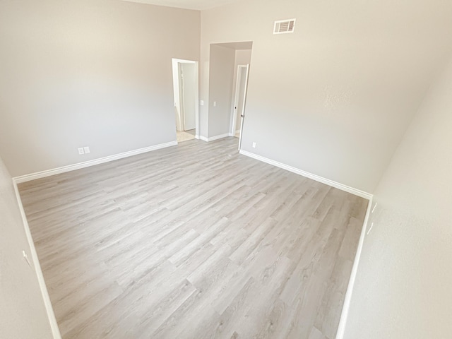 unfurnished room with light wood-type flooring