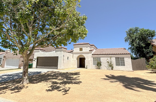 mediterranean / spanish home featuring a garage