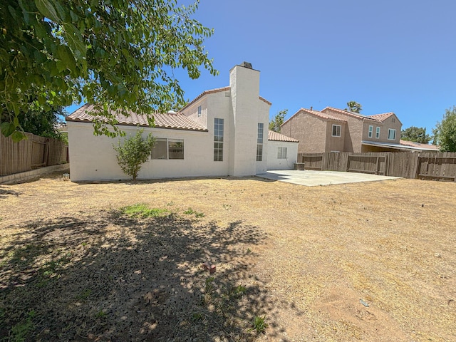 back of property with a patio