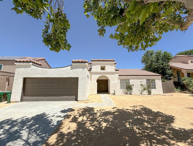 mediterranean / spanish home with a garage