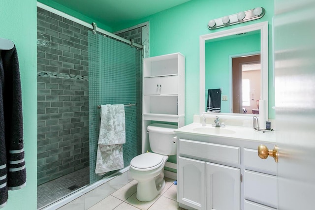 bathroom with toilet, vanity, tile patterned floors, and walk in shower