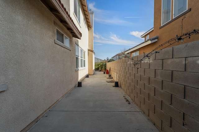 view of side of home with a patio area