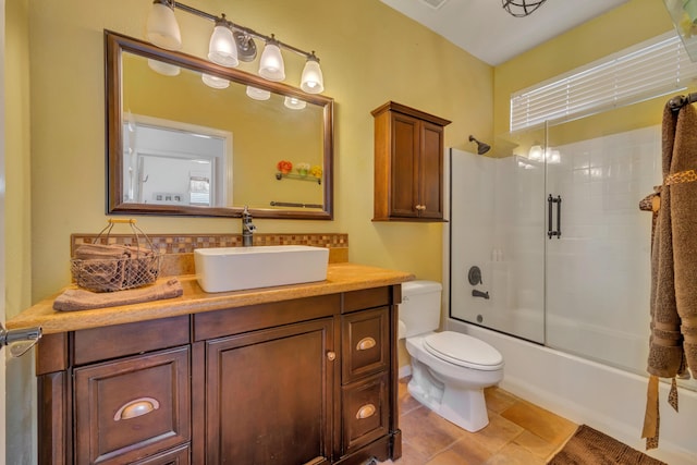 full bathroom featuring combined bath / shower with glass door, toilet, tile patterned floors, and vanity