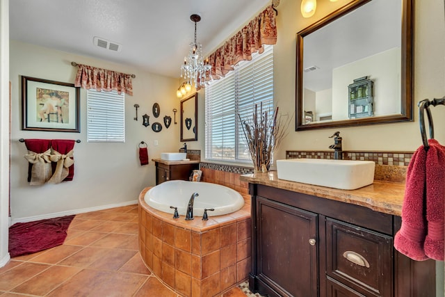 bathroom with vanity, a notable chandelier, a relaxing tiled tub, and tile patterned flooring