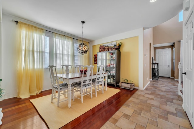 dining room featuring an inviting chandelier and light wood-type flooring