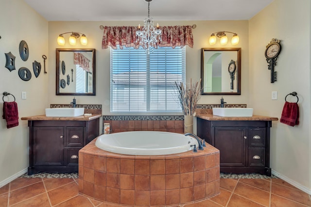 bathroom with a relaxing tiled tub, tile patterned floors, vanity, and a notable chandelier