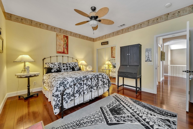 bedroom with ceiling fan and dark hardwood / wood-style flooring