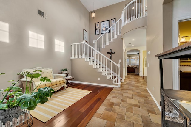 entryway featuring a towering ceiling