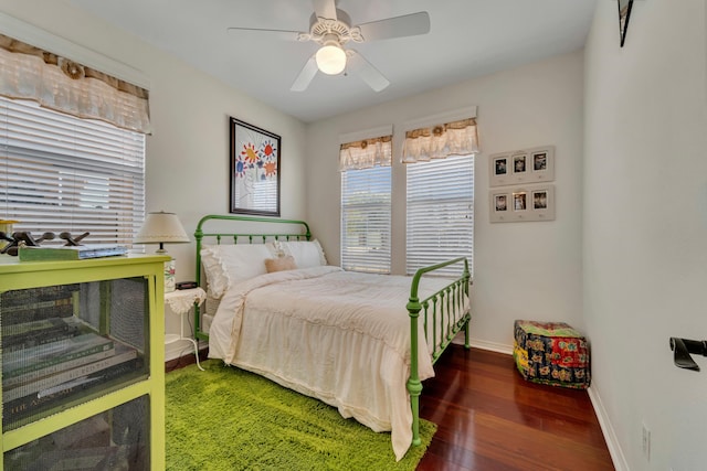 bedroom with ceiling fan and dark wood-type flooring