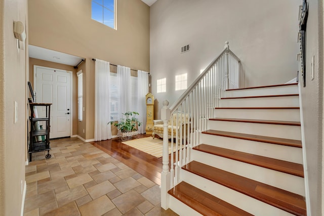 foyer entrance featuring a wealth of natural light and a towering ceiling