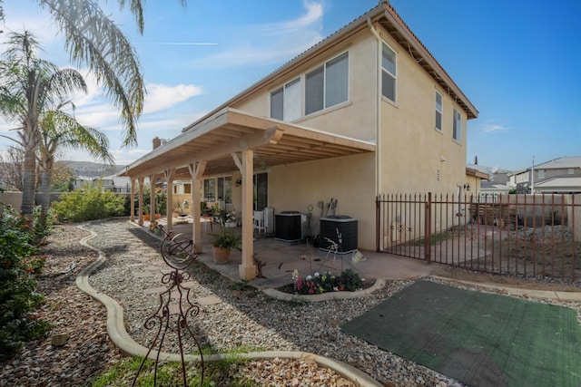 rear view of property featuring cooling unit and a patio