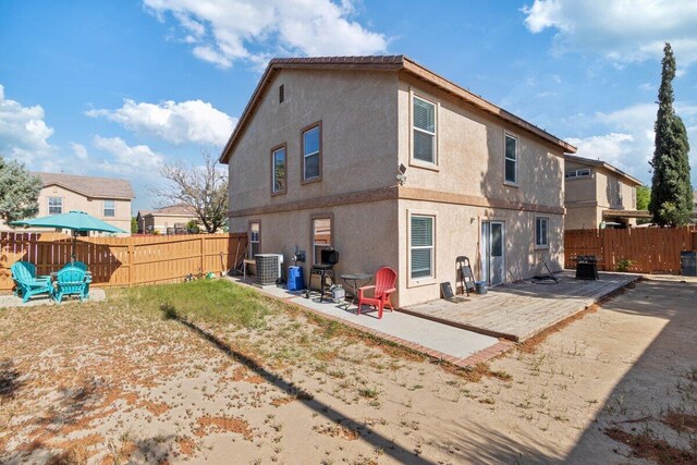 40305 Reata Rd, Palmdale, CA 93550 - back of property with a patio, a fenced backyard, cooling unit, and stucco siding
