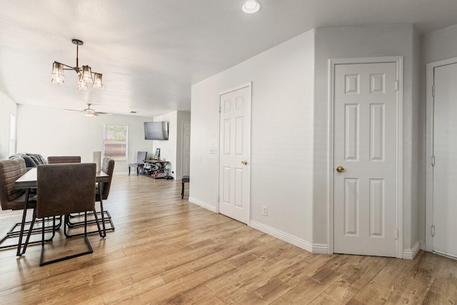 40305 Reata Rd, Palmdale, CA 93550 - dining area featuring a chandelier, light wood-type flooring, and baseboards