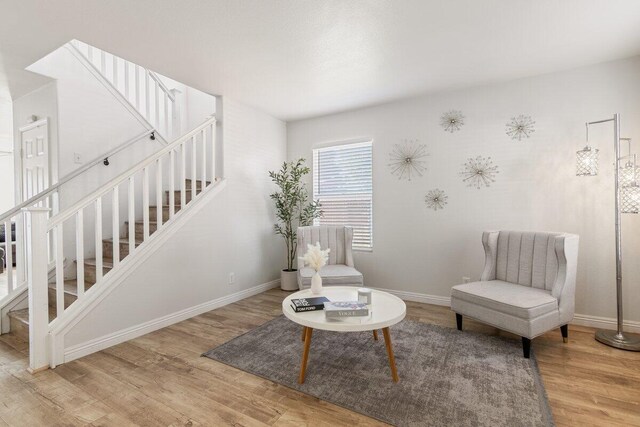 40305 Reata Rd, Palmdale, CA 93550 - living area featuring stairway, wood finished floors, and baseboards