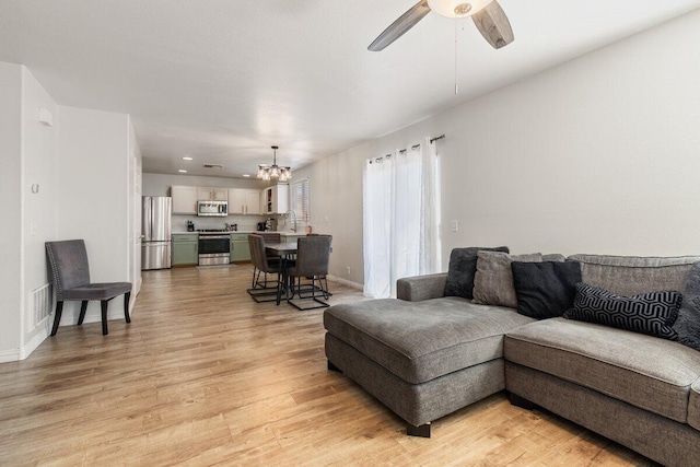 40305 Reata Rd, Palmdale, CA 93550 - living area featuring a chandelier, light wood-style flooring, ceiling fan, baseboards, and recessed lighting