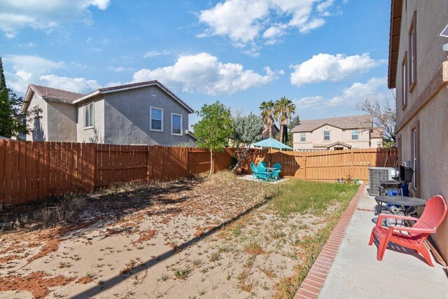 40305 Reata Rd, Palmdale, CA 93550 - fenced backyard featuring cooling unit and a patio area