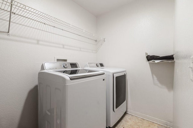 40305 Reata Rd, Palmdale, CA 93550 - washroom with separate washer and dryer and baseboards