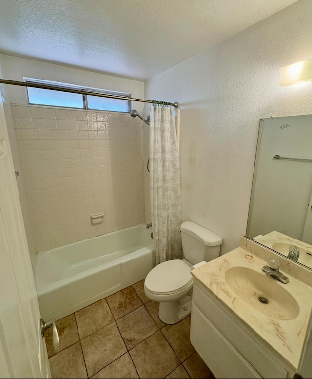 full bathroom featuring shower / tub combo with curtain, toilet, a textured ceiling, vanity, and tile patterned flooring