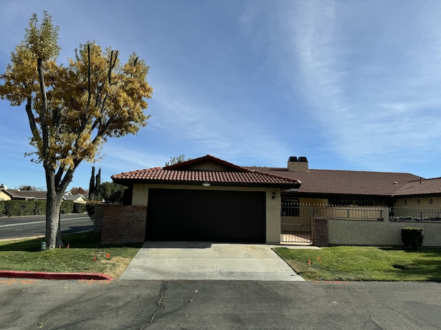 view of front facade featuring a garage, driveway, a fenced front yard, and stucco siding