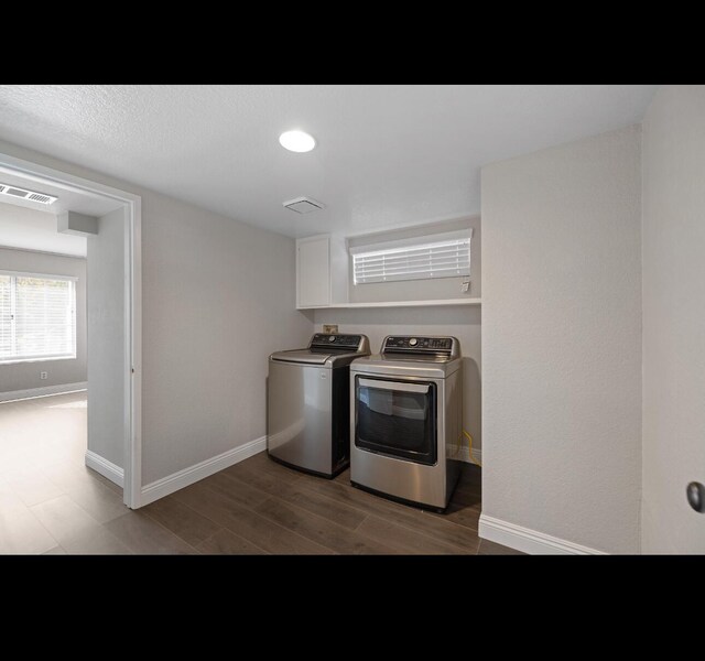 washroom featuring independent washer and dryer and dark hardwood / wood-style floors