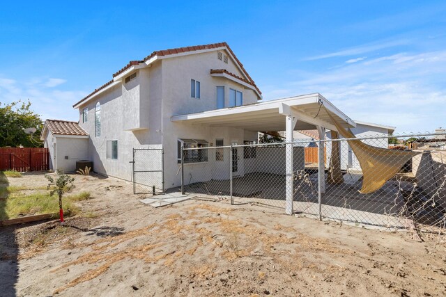 back of house with a carport