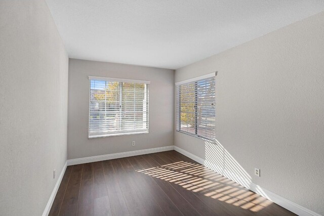 empty room featuring dark hardwood / wood-style flooring